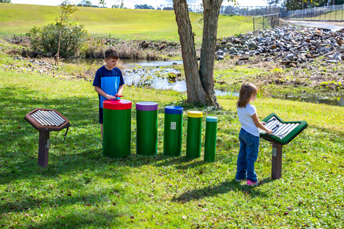 Freenotes Early Childhood Ensemble Musical Playground Set, children playing on colorful percussion instruments outdoors.