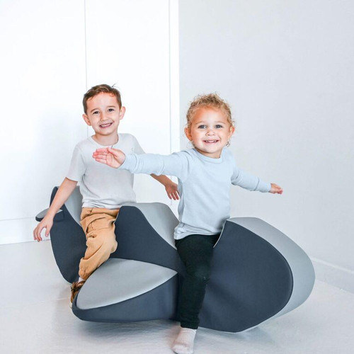 Children's Factory Rocket the Rocker Double Airplane Foam Toddler Rocker, two kids playing on a modern foam airplane-shaped rocker in a bright room.