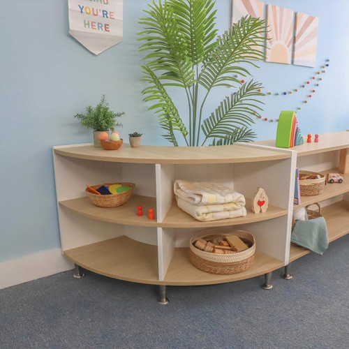 Whitney Brothers elevatED™ Curve In Cabinet - 27"H, wooden storage cabinet with a curved design and multiple shelves in a classroom setting.