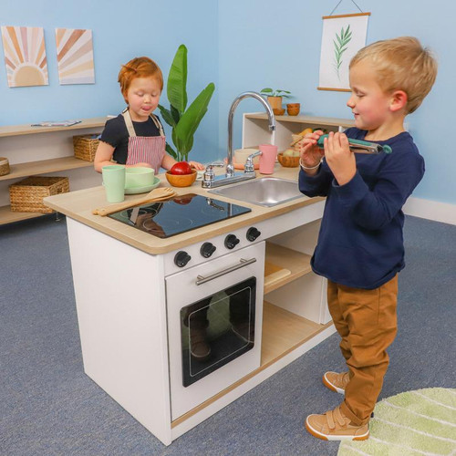 Whitney Brothers elevatED™ Kitchen Island Breakfast Bar, children playing and pretending to cook with play kitchen set.