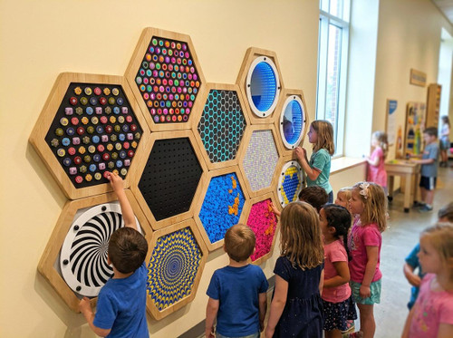 LiteZilla Multi-Sensory Hexagon Panel - Mini Lite Brite Classic, colorful interactive sensory wall with children engaging and creating patterns.