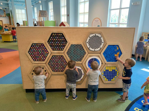 LiteZilla Multi-Sensory Hexagon Panel - Spinfinity Classic, an interactive sensory play panel with colorful hexagon-shaped sections designed for children to explore and engage.
