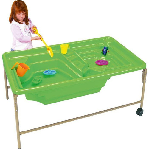 Moje Bambino Steps and Locks Mobile Sand and Water Play Table, green plastic table with built-in sand and water compartments, children's toys, and a young girl playing with a yellow shovel.