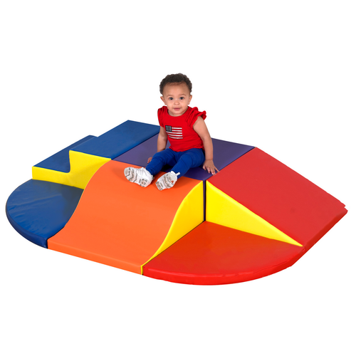 Children's Factory Activity Play Zone Soft Play Climber, a colorful padded soft play area with a small climbing structure, featuring red, yellow, orange, and blue sections with a young child sitting on top.