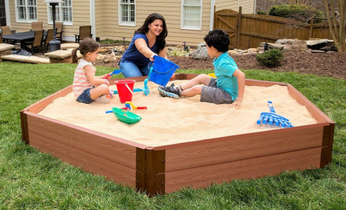 Frame It All Hexagon Wooden Sandbox Kit - 2" Profile - 7' x 8' x 11", children playing and building in a large wooden sandbox with sand toys in a backyard setting.