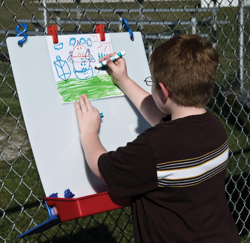Childbrite Single Fence Children's Art Easel, boy drawing on a whiteboard attached to a fence with colorful markers.