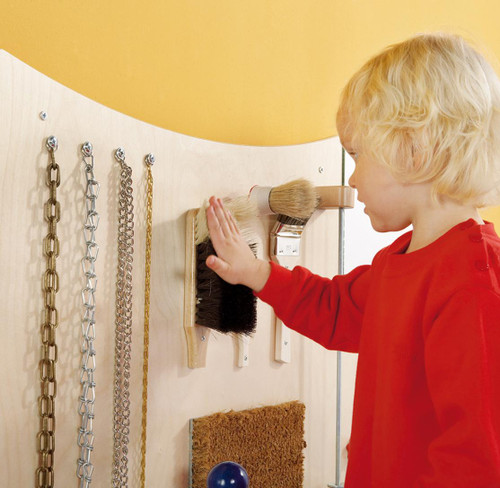 HABA Pro Sensory Learning Wall 'Dip A' Wall Panel Toy, child touching brushes on sensory wall.