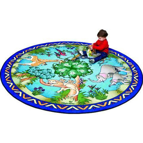 Playscapes Animal Families Kids Area Carpet, a round colorful play carpet featuring various animal illustrations and forest scenery, with a child sitting on it.