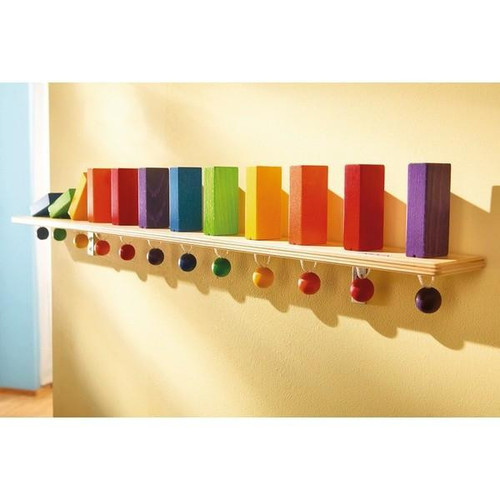 12 Rainbow Dominoes Wall Activity Panel, colorful wooden dominoes arranged on a wall-mounted wooden shelf with colored balls underneath.