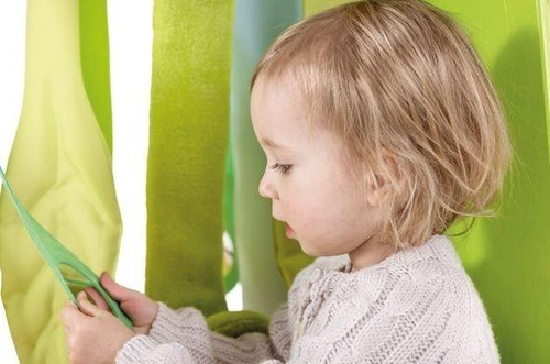 HABA Pro Grow.upp Wide Trapezoid Cabinet with Sensory Leaves, child exploring colorful sensory leaves in a vibrant play area.