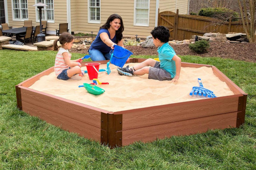 Frame It All Hexagon Sandbox with Collapsible Cover, children playing in the sandbox with sand toys in a backyard garden.