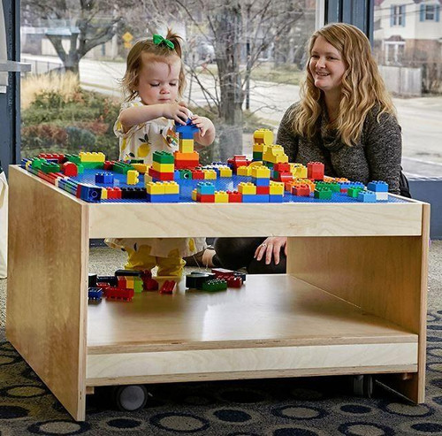 Playscapes 3-branch Discovery Mini Children's Activity Table, children playing with colorful building blocks inside a play area.