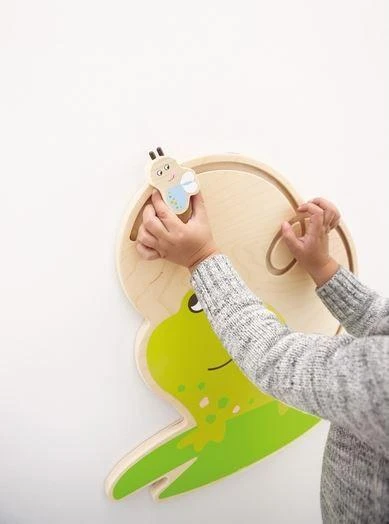 HABA Pro Freddie the Frog Interactive Wall Decor, a green frog-shaped wall mounted toy with a Freddie the Frog character attached.