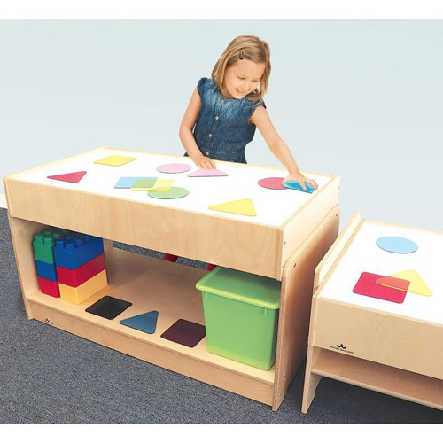 Whitney Brothers Superbright LED Large Light Table, child playing with colorful geometric shapes on a light-up educational table.