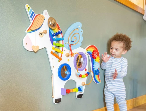 SPARK & WOW Unicorn Activity Wall Panel, colorful educational wall toy with various shapes, gears, mirrors, and beads designed for children's play and development.