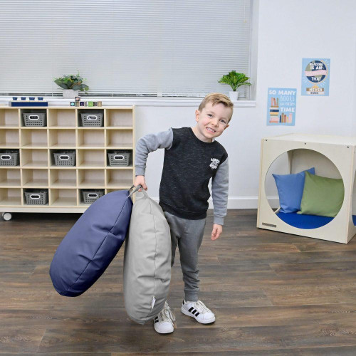 Children's Factory Mini Round Pouf with Handle - Gray and Navy, children holding poufs in a playroom setting.