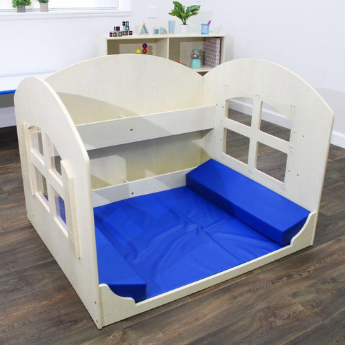 Angeles Reading Nook with Book Shelves, a children's wooden bed with blue mattress and built-in window cutouts for play and reading, in a modern room setting.