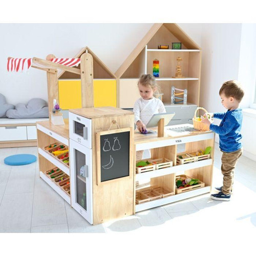 Moje Bambino Mini Market Play Store Set, children playing with a wooden toy market set in a bright playroom.