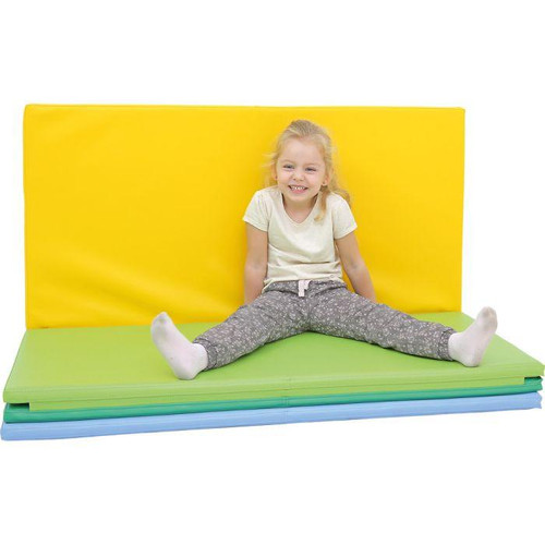 Moje Bambino Folding Floor Mat for Classroom, yellow and green mats with a young girl sitting on it in a classroom setting.