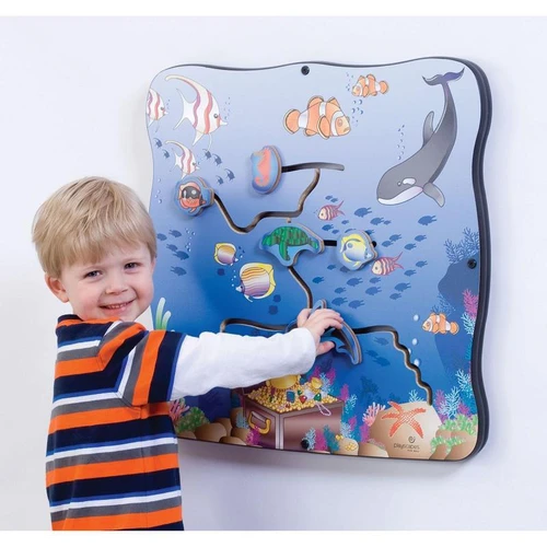 Playscapes Seascape Explorer Activity Wall Toy, a kid engaging with a colorful aquatic-themed maze activity wall featuring fish, sharks, and coral designs.