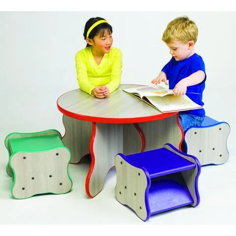 Playscapes Kids Wavy Stools, colorful wavy shaped children’s seating around a table with two kids engaging with a book.