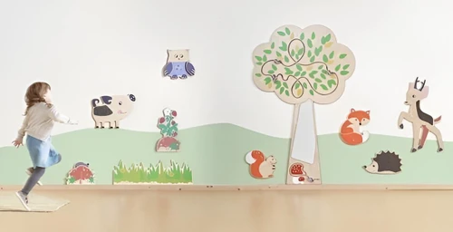 HABA Pro Tree Mirror Interactive Wall Decor, children playing near a wall decorated with a tree, animals, and interactive elements.