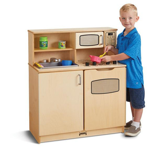 Jonti-Craft Chef’s Wooden Play Kitchen, a child's play kitchen set with stove, microwave, sink, and shelves with toy pots and utensils, in natural wood finish with a boy playing cooking.