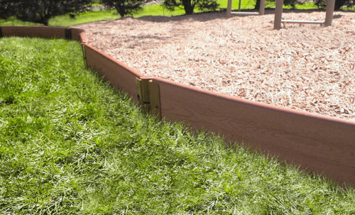 Frame It All Classic Sienna Straight Playground Border 16' - 1" Profile, wooden fencing for playground edging with mulch surface and green grass in the background.