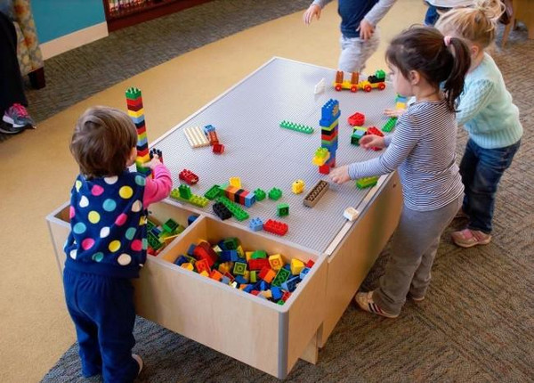 Playscapes 3-branch Discovery Lego Table, children playing and building with various colorful Legos.