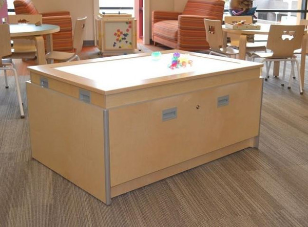 Playscapes 3-Branch Lightbox Discovery Table, wooden table with illuminated surface in a playroom or educational setting.