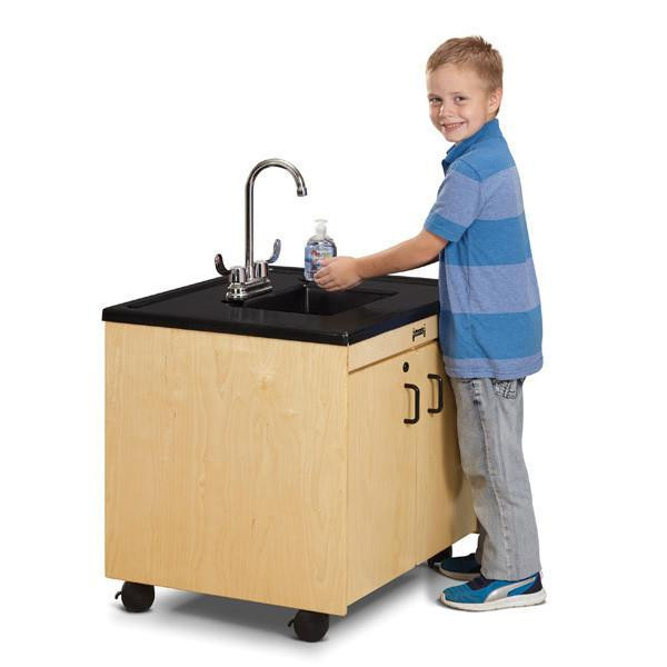 Jonti-Craft Clean Hands Helper Portable Plastic Sink - 26" Counter, image of a young boy washing his hands at a portable plastic sink with a wooden cabinet and black countertop.