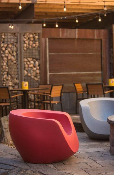 Playscapes Moon Chair, modern pink and blue outdoor lounge chairs in a rustic patio setting.