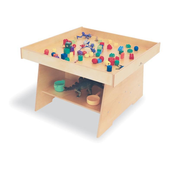 Whitney Brothers Big Wide Discovery Table, wooden children's activity and play table with a spacious top surface filled with colorful building blocks and figurines, and a lower shelf with storage bowls and a small toy animal.