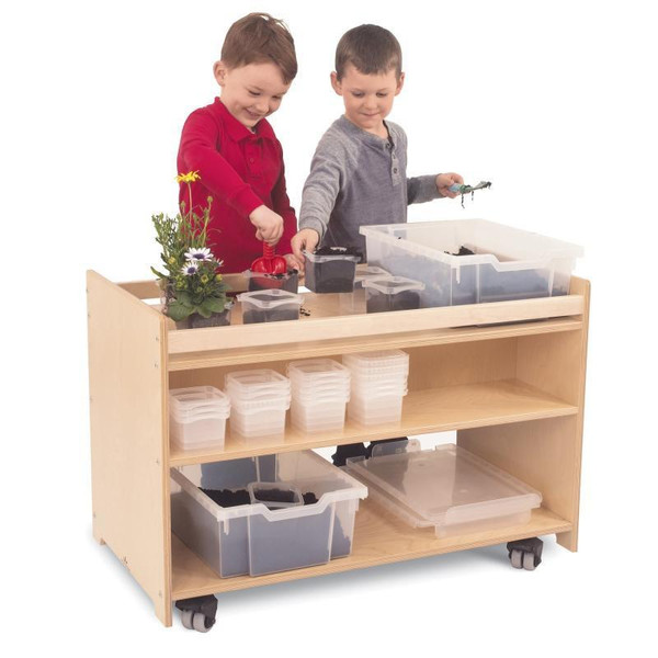 Whitney Brothers Mobile Garden Center, children engaging in gardening activity using various pots, tools, and plants on a wooden mobile garden station.