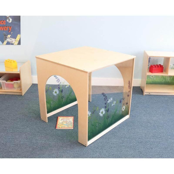 Whitney Brothers Nature View Playhouse Cube, children's wooden playhouse with nature-themed side panels featuring flowers and grass, in a classroom setting.