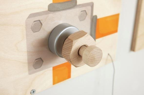 HABA Pro Mechanic Sensory Wall Panel, wooden and metallic mechanical sensory toy with a wooden handle attached to a wall.