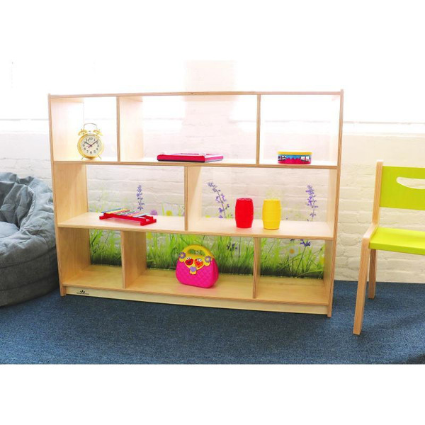 Whitney Brothers Nature View Acrylic Back Storage Cabinet 36" H, wooden storage unit with glass back panels and open shelves, colorful toys and decor displayed inside, set in a bright room with a green chair and plush seat.