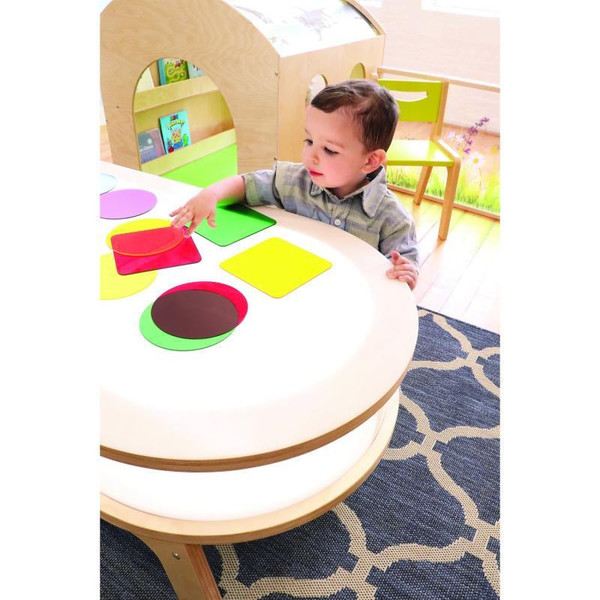 Whitney Brothers 6 Color Wheel Circles for Light Tables, educational toy with six colorful circles on a light table being used by a young child for learning and play.