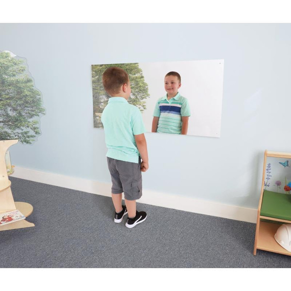 Whitney Brothers Shatterproof Acrylic Large Mirror, a young boy standing in front of a large mirror mounted on the wall, looking at his reflection.