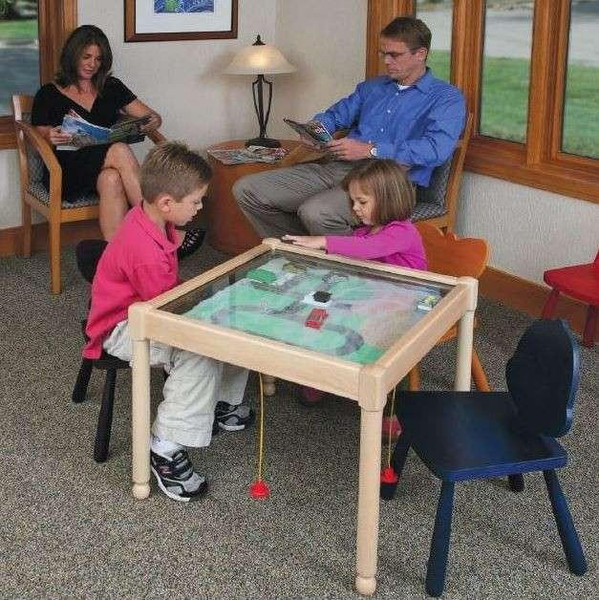 Playscapes Square Bees & Flowers Play From The Top Activity Table - 18 inches high, with children playing a tabletop game while adults sit nearby in a cozy, well-lit room with large windows.