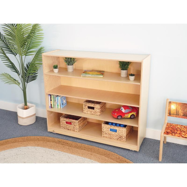 Whitney Brothers Mobile Bookshelf Cabinet 42H, wooden bookshelf with three shelves holding books, baskets, and children's toys in a room with a potted plant and a chair.