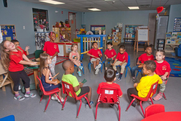 Playmore Designs Eco Percussion Set with Box and Sorter, children playing with percussion instruments in a classroom.