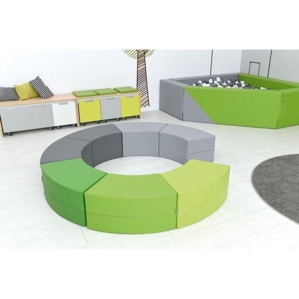 Moje Bambino Paolo Short Curved Foam Bench Seats, colorful circular foam seating with green and gray sections arranged in a modern playroom setting.