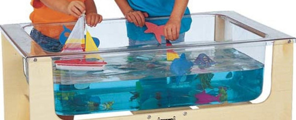 Jonti-Craft See-Thru Wooden Sensory Table Replacement Tub Only, clear plastic sensory table trough filled with water and toys, children playing with toys inside the table.