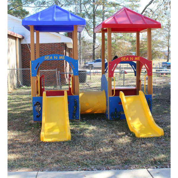 Infinity Playgrounds Sea N Me Tot Toddler Playground Climber, colorful outdoor playground with two towers, two slides, and a tunnel connecting them, designed for children's play and recreation.