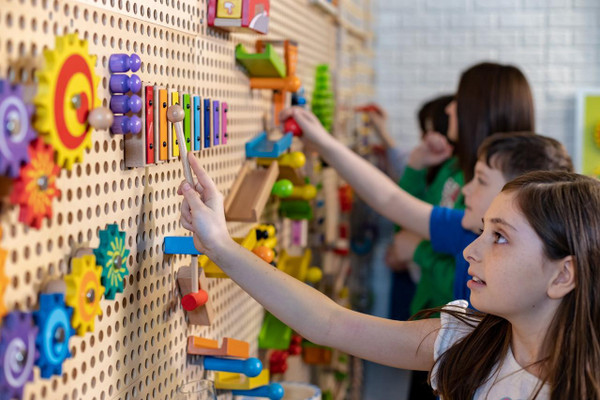 LiteZilla KidWorx™ Melody Magic Xylophone Wall Marble Run, colorful educational toy for children with various mounted gears and musical instruments on a pegboard.