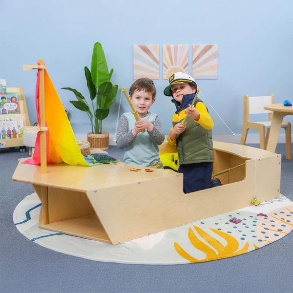 Whitney Brothers Imagination Boat Activity Center, children playing with toy fishing poles and pretending to boat on wooden boat playset.