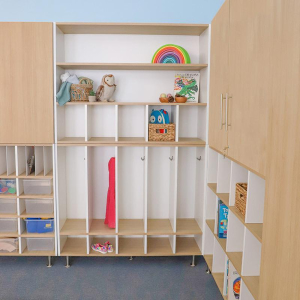 Whitney Brothers elevatED™ Five Section Coat Locker, modern multi-section coat storage unit with cubbies, hooks, and shelves in a children's playroom or classroom setting.