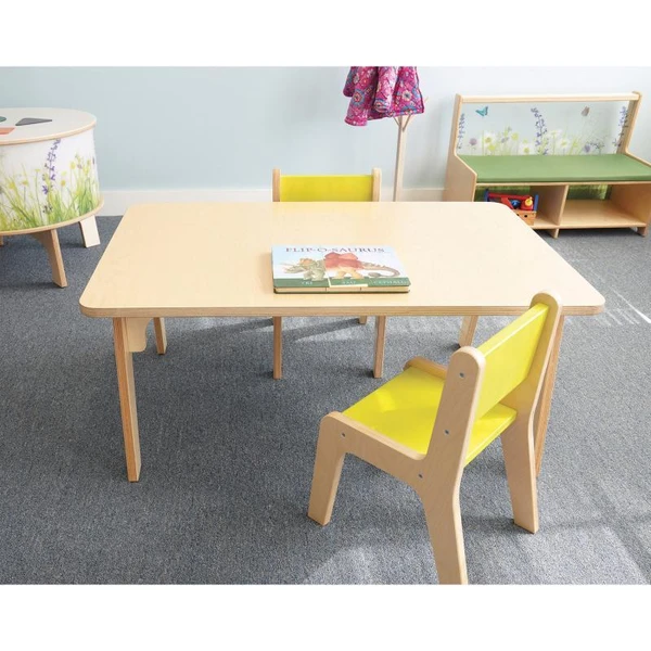 Whitney Brothers Whitney Plus Rectangle Classroom Table - 20H, light wooden table with a yellow chair and a children’s book on top, in a preschool or classroom setting.