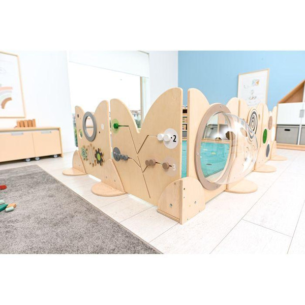 Moje Bambino Wall Mounting Element for Sensory Play Panels, wooden interconnected sensory play structure with transparent tunnel and various sensory elements in a children’s playroom.